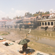 Brahmanand sitting on the banks across the pyres.